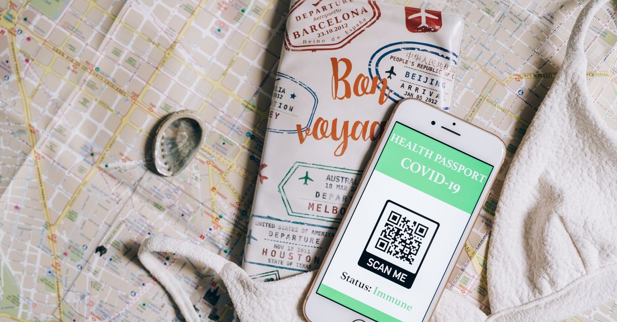 Smartphone displaying a health passport with QR code on a travel map and passport cover.